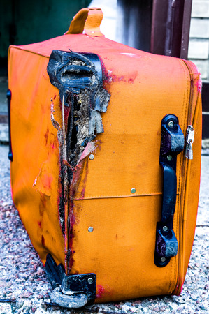 Broken traveling luggage on the groundの写真素材