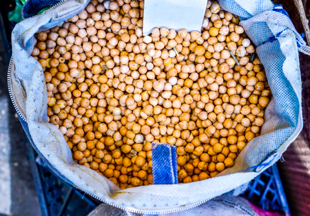 top view to bright yellow orange organic natural raw lentil ripes in white pocket. lentil as agricultural healthy food background. red raw lentil texture as backgroundの写真素材