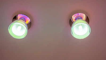 Small geometrical lamps with light inside on ceilling. Warm light from a lamp on the ceiling.の写真素材