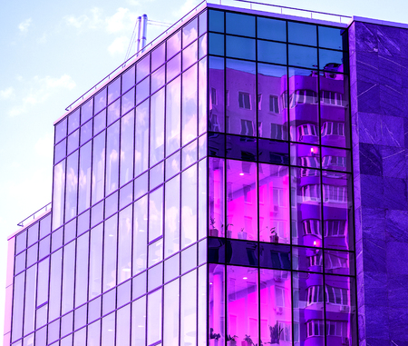 Panoramic and perspective wide angle view to steel light blue background of glass high rise building skyscraper commercial modern city of future. Business concept of successful industrial architectureの写真素材