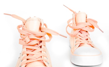 modern crimson new sneakers with white foot and wide open shoelaces on white. modern stylish sneakers isolated on white background. new high keds for woman or man stay strong front viewの写真素材