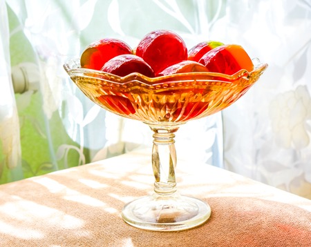 three color green red yellow home made jelly eggs on clean glass plate against home background....