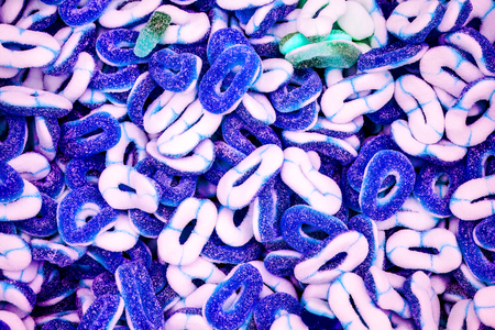 sweet candy background. chaotic sweet colorful jelly ovals and circles in sugar. jelly circles breaded in sugar. natural jelly candy as present and dessert for childrenの写真素材