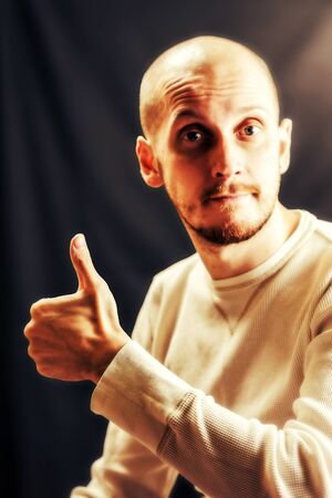 white skin man with like hand in white shirt on black back