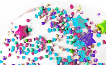 colorful sugar balls and stars on whiteの写真素材