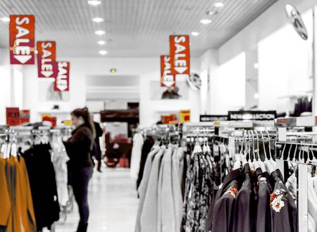 Clothes hang on a shelf in a designer clothes store in Melbourne, Australiaの写真素材