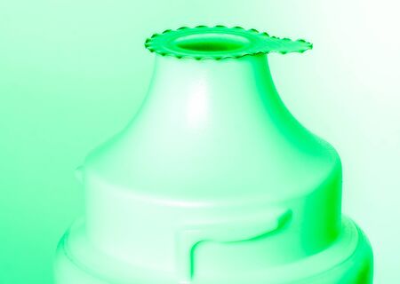 top part of plastic tube for tooth paste or creme in green lightの写真素材