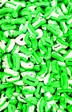 many sugar jelly candies as many homemade green white teetsの写真素材