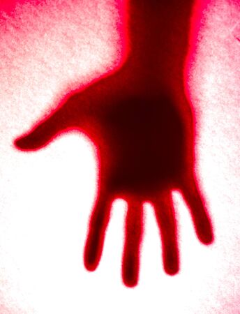 Shadow hands of the Man behind frosted glass.の写真素材