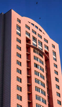 high red multi storey house under blue skyの写真素材