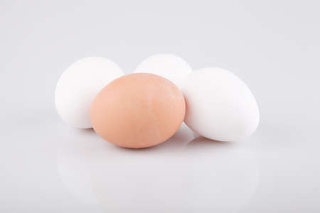 Brown and white eggs on a white surface. Eggs isolated on white background.