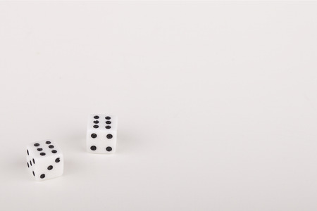 A pair of six on a roll of the dice on a white surface. Dice isolated on white background.の写真素材