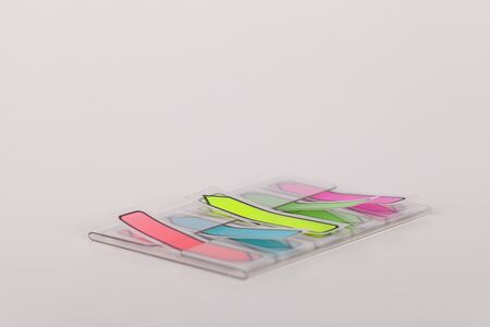 Colorful sticky tabs on a white surface. Sticky tabs isolated on white background.