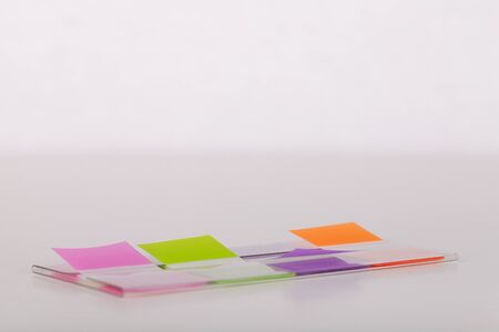 Colorful sticky tabs on a white surface. Sticky tabs isolated on white background.