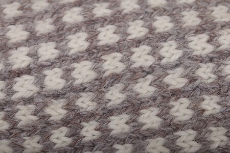 Close up of grey and white knitting texture. Macro of woollen texture.