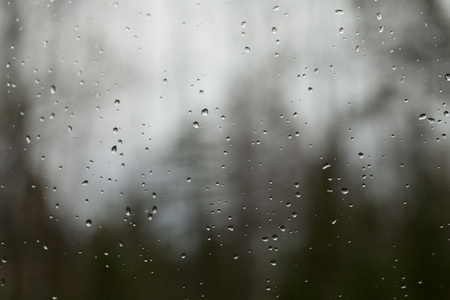 Rain drops on the window against a nice blurry background. Abstract, texture, background.の写真素材