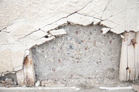 Broken gritty concrete cover on cinder blocks. Worn out cement falling off a wall. Textured abstract...