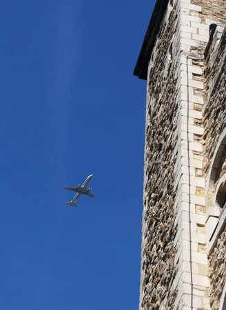 A plane skimming the roofの写真素材