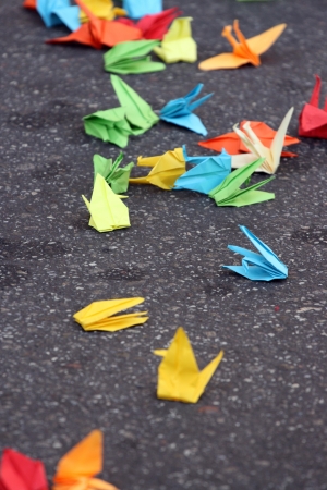 Many coloured origami cranes on gray backgroundの写真素材
