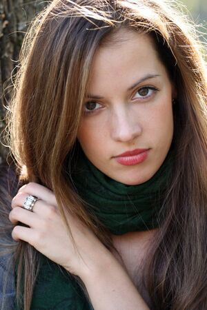 Portrait of young brunette woman in green scarf.の写真素材