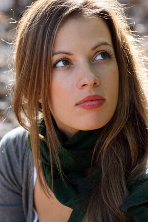 Portrait of young brunette woman in green scarf.の写真素材