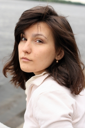 Portrait of beautiful haughty woman with disorder hair on water background.の写真素材