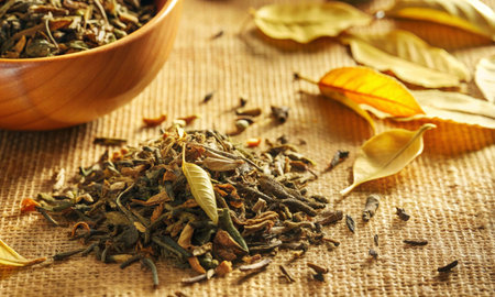 Dried tea leaves are lying on the table in the rays of lightの素材