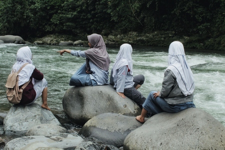 students on the riverbank