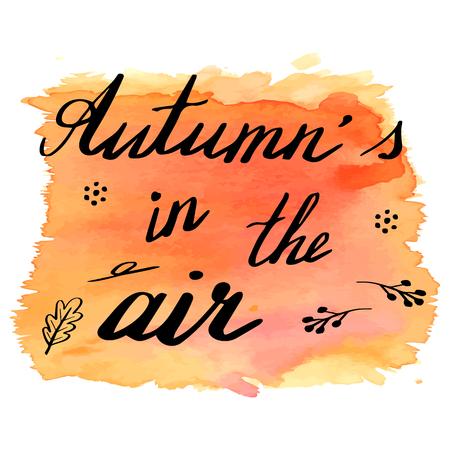 Hand written phrase Autumn's in the Air on abstract hand painted watercolor texture. Colorful autumn banner template with hand lettering isolated on white background. Vector illustration.のイラスト素材