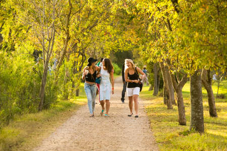 Johannesburg, South Africa - May 10 2014: Girls walking on a path having fun in a Parkのeditorial素材