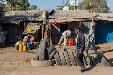 Addis Ababa, Ethiopia, January 30, 2014, Tire salesman on a busy street with various informal shops...
