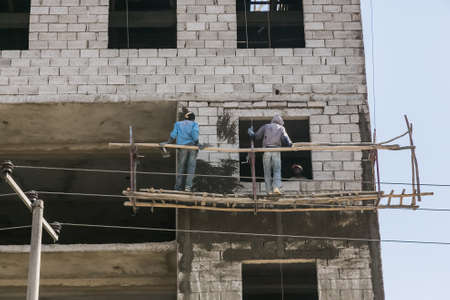 Addis Ababa, Ethiopia, January 30, 2014, Construction workers on a hanging scaffoldのeditorial素材