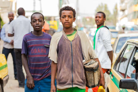 Addis Ababa, Ethiopia, January 27, 2014, Children working as shoe shine boys on the street, looking straight at the cameraのeditorial素材