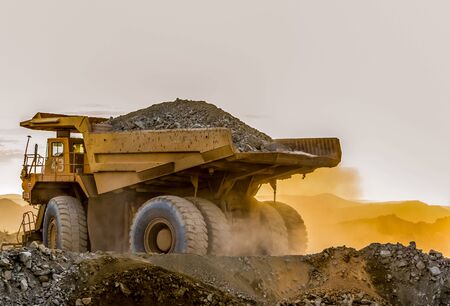 Mining dump trucks transporting Platinum ore for processing