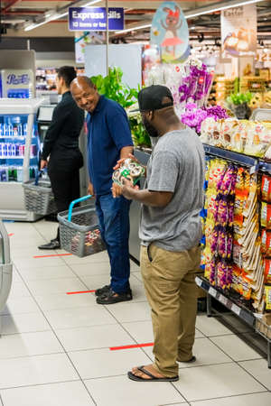 Cape Town, South Africa - March 23, 2020: Retail shoppers practicing social distancing at Pick 'n Pay grocery store during virus outbreakのeditorial素材