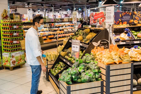 Cape Town, South Africa - March 23, 2020: Person wearing a protective mask while shopping at Pick 'n Pay grocery store during virus outbreakのeditorial素材