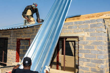 Soweto, South Africa - September 05, 2009: Diverse Community Outreach program helping to install...