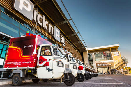 Johannesburg, South Africa - October 19, 2014: Small TukTuk Grocery Store Home Delivery Vehicles lined up at a supermarketのeditorial素材