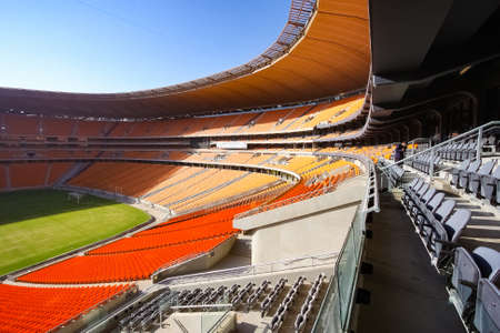 Johannesburg, South Africa - April 15, 2010: Empty Soccer Football stadium with orange seatingのeditorial素材