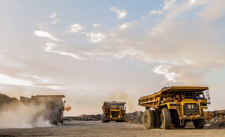 Dump Trucks transporting Platinum ore for processingの写真素材