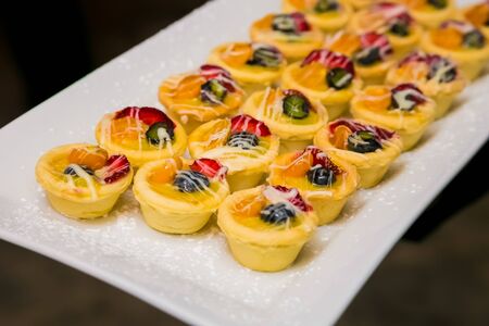 Small Custard and berry fruit tart pudding dessert for catering at gala dinner banquet eventの写真素材