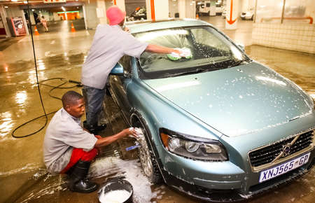 Johannesburg, South Africa - April 27 2011: African Man washing a car at a underground carwashのeditorial素材