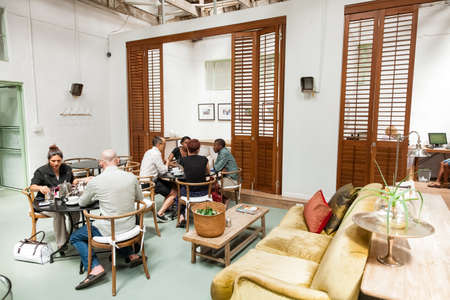 Johannesburg, South Africa - January 14, 2013: Customers sitting inside small independent fair trade coffee shopのeditorial素材