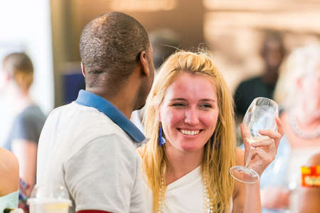 Johannesburg, South Africa - October 15 2016: A young couple drinking, eating and generally enjoying a day out at a Food and Wine Fair drinking and generally enjoying a day out at a Food and Wine Fairのeditorial素材