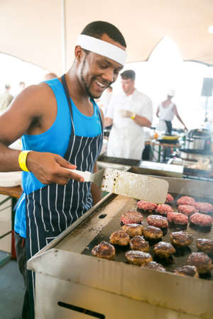 Johannesburg, South Africa - October 10 2015: Chef making and serving take-away meals at food festival vendor stallのeditorial素材