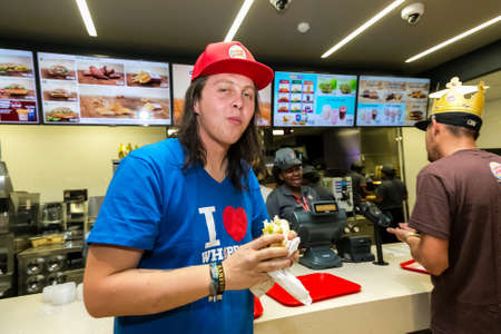Johannesburg, South Africa - June 27, 2014: Male customer eating  at a Burger King Restaurant