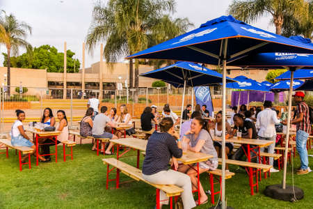 Johannesburg, South Africa - September 11, 2015: Diverse Friends eating, drinking and generally enjoying a day out at a outdoor beer gardenのeditorial素材