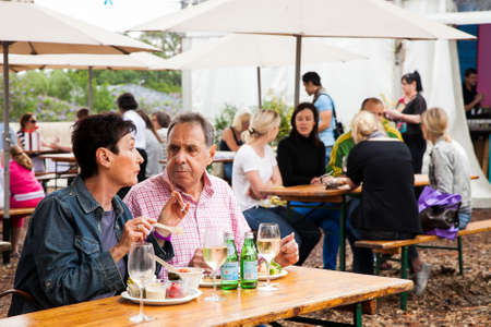 Johannesburg, South Africa - November 24 2012: Middle aged couple eating, drinking and generally enjoying a day out at a Food and Wine Fairのeditorial素材