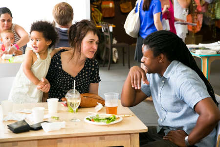 Johannesburg, South Africa - November 10 2013: A young diverse family enjoying a day out at a Food and Wine Fair drinking and generally enjoying a day out at a Food and Wine Fairのeditorial素材