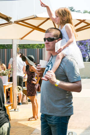 Johannesburg, South Africa - October 10 2015: A father and daughter enjoying a day out at a Food and Wine Fair drinking and generally enjoying a day out at a Food and Wine Fairのeditorial素材